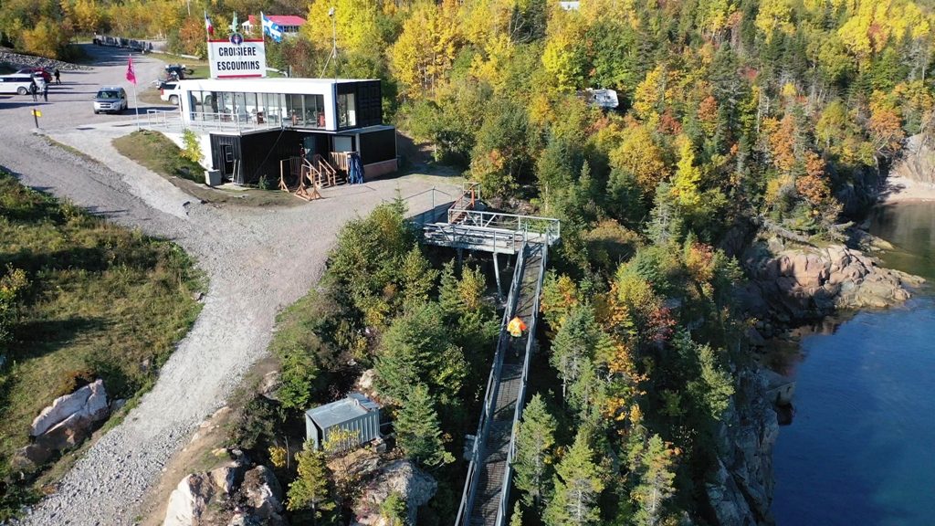 Vue aérienne de nos installations : le bâtiment, le stationnement et l'escalier qui descend au quai